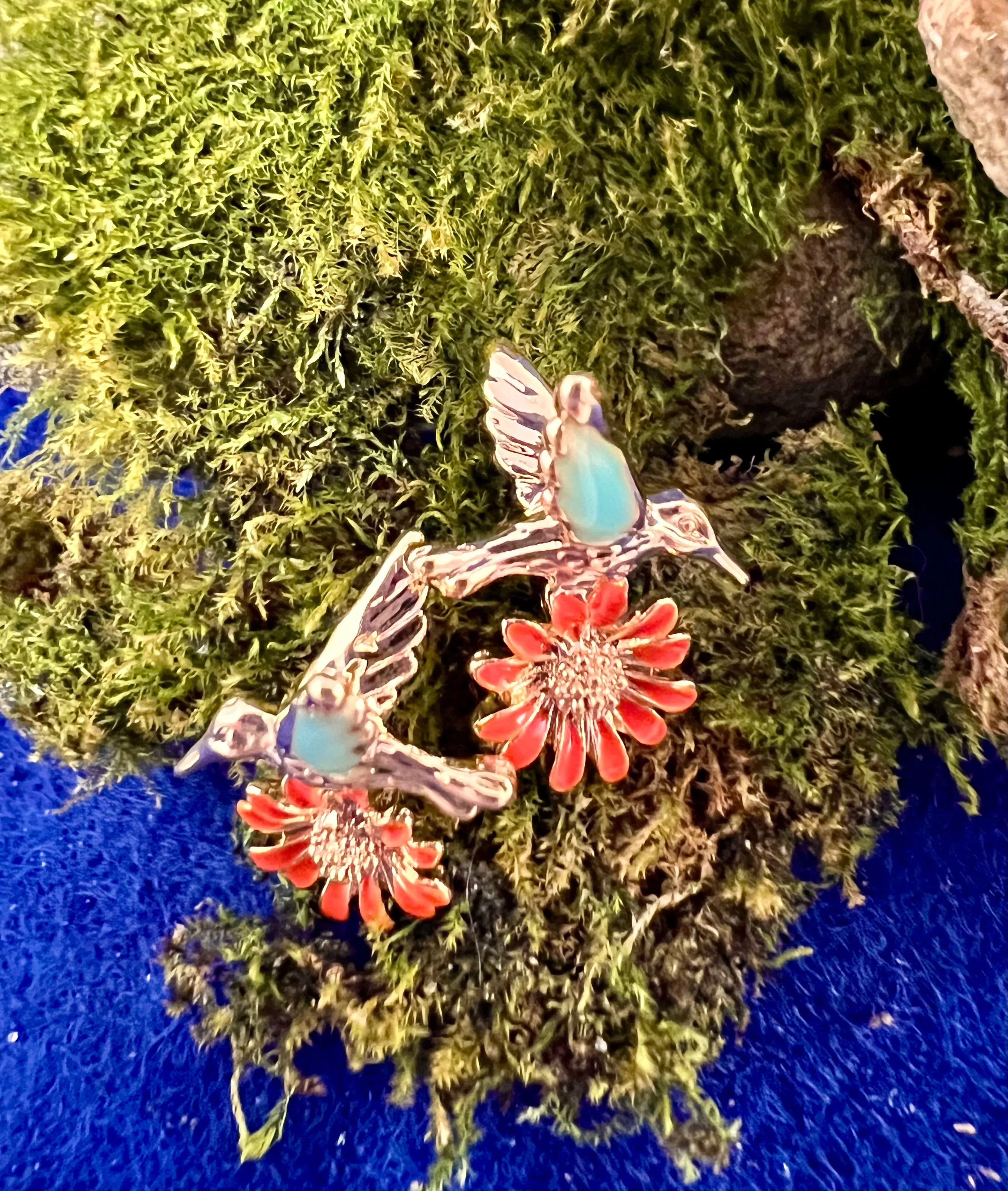 Teal Winged Bird with Orange Flower